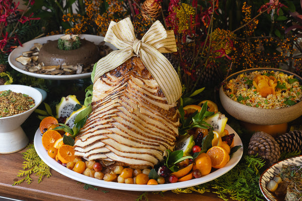 Peru inteiro fatiado acompanhado de cebolas caramelizadas, frutas cítricas e seu próprio molho